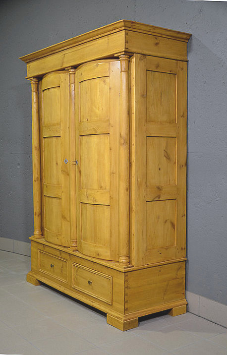 Rechte Seitenansicht des antiken Biedermeier Bauernschranks aus massiver Kiefer, mit klarer Linienf&uuml;hrung und Kassettenf&uuml;llungen, restauriert, pers&ouml;nliche Lieferung deutschlandweit.