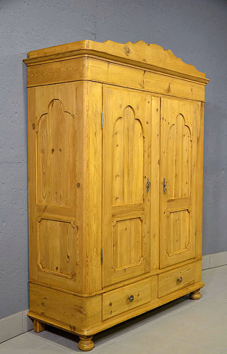 Linke Seitenansicht des Biedermeier Kleiderschranks aus massiver Kiefer, dezent profiliert und harmonisch in den Proportionen.