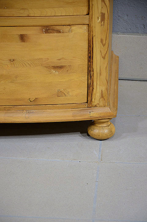 Sockelansicht der antiken restaurierten Jugendstil Kommode aus massiver Kiefer mit stabilem Stand. Wir liefern zuverl&auml;ssig, kosteng&uuml;nstig und pers&ouml;nlich &ndash; deutschlandweit bis in Ihr Zuhause. Nach Terminvereinbarung k&ouml;nnen Sie dieses M&ouml;belst&uuml;ck gerne in unserem M&ouml;bellager in Bargfeld-Stegen besichtigen.