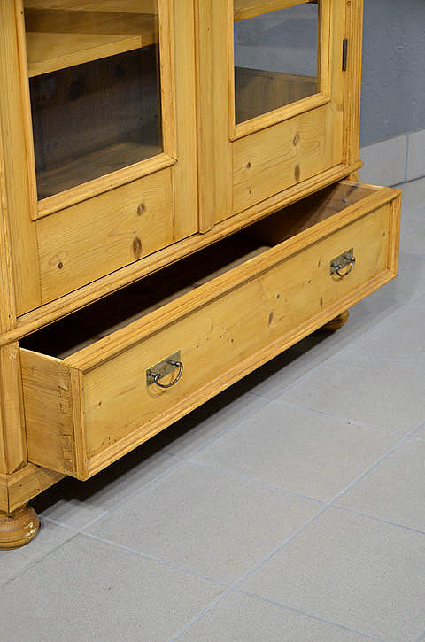 Schraegansicht der antiken dreiseitig verglasten Gruenderzeit Vitrine mit ausgezogener und gezapfter Schublade.